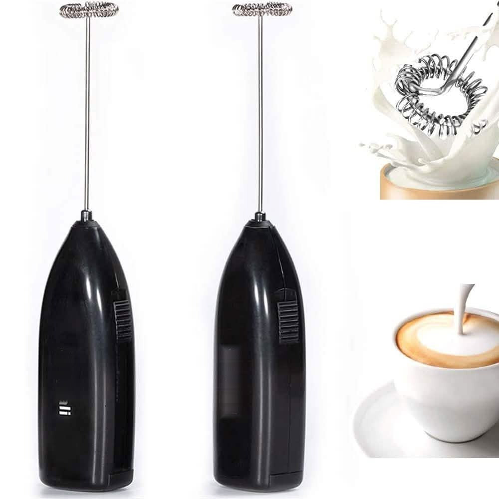 Two black handheld milk frothers with stainless steel whisk heads and a splash of frothed milk
